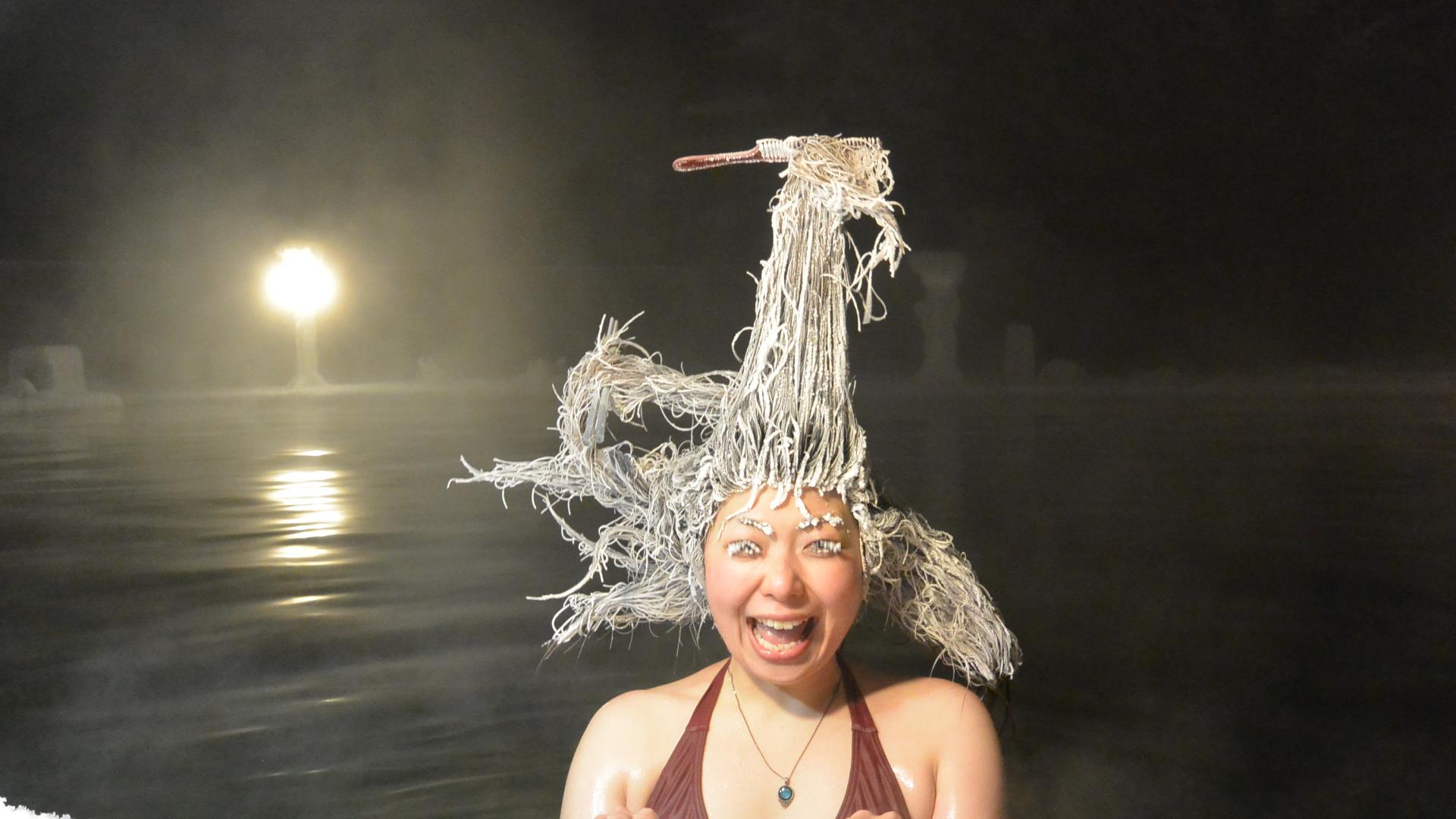 photo of woman with frozen hair. brush and chopsticks are frozen into her hair