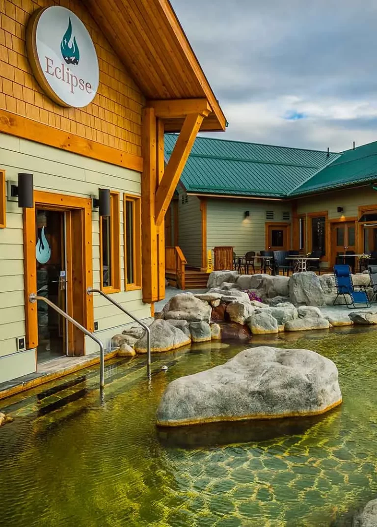 Wooden building built in front of a natural pool