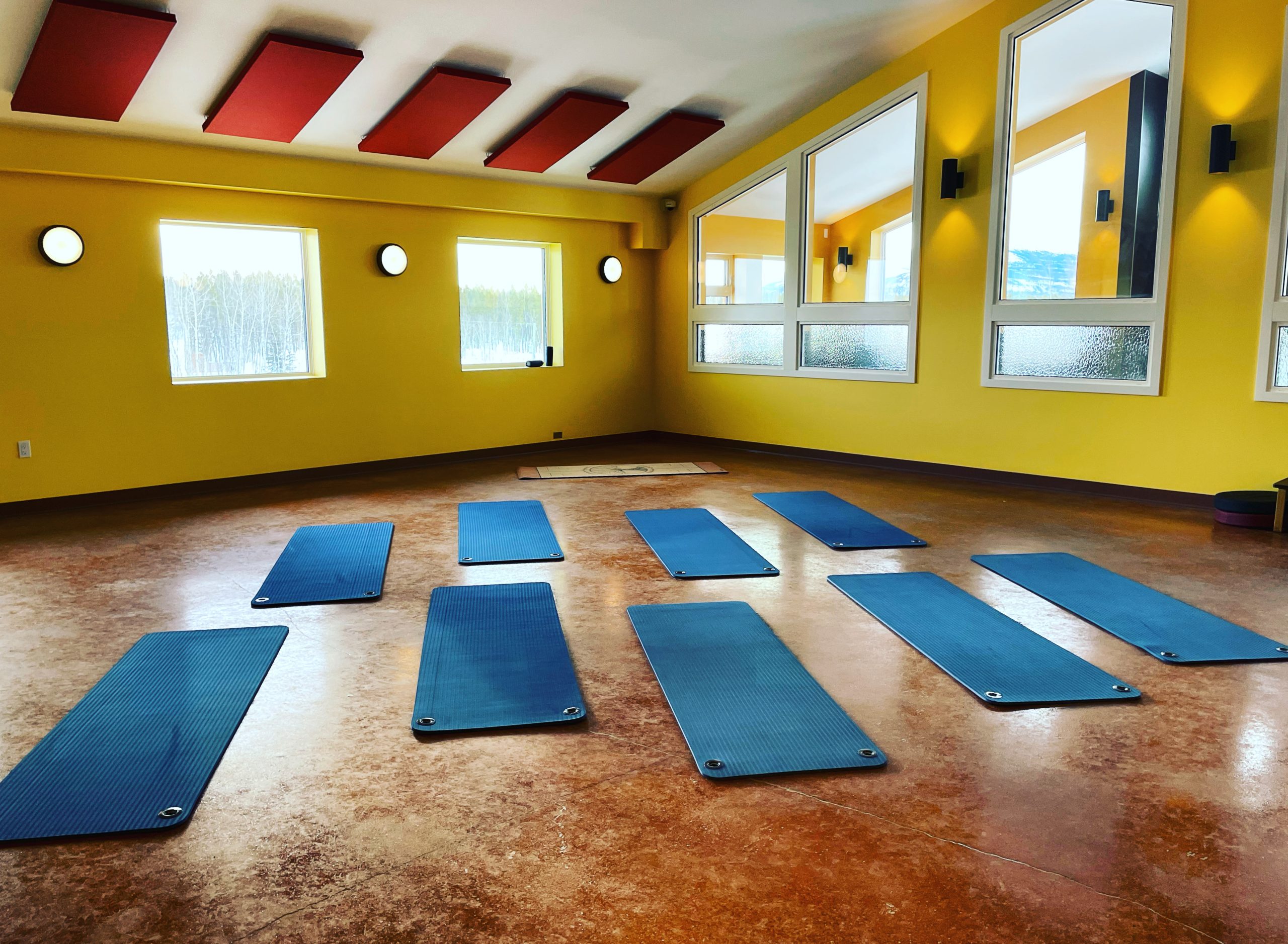 yoga mats laid on the floor of a bright well-lit room